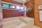 The master bath features a large soaking tub with shower head
